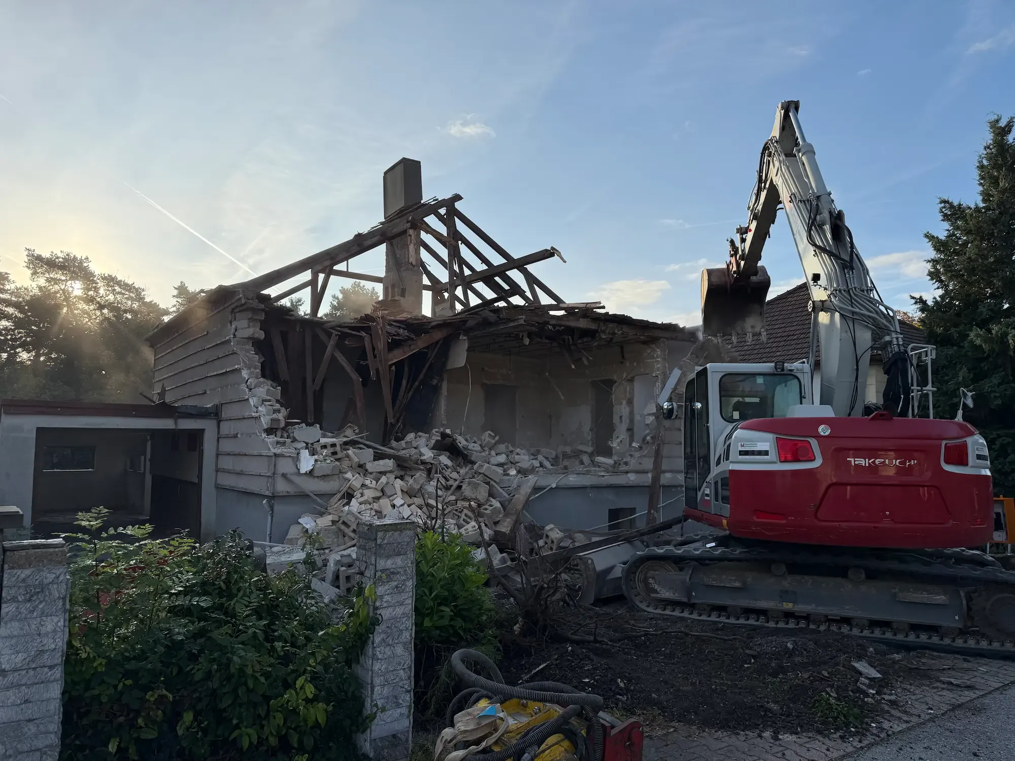 Bagger der EMK beim Abbruch eines alten Hauses